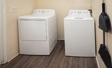 white washing machine laundry room with a white machine washer and dryer 