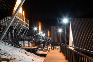 A Frame cabins at night in the winter park