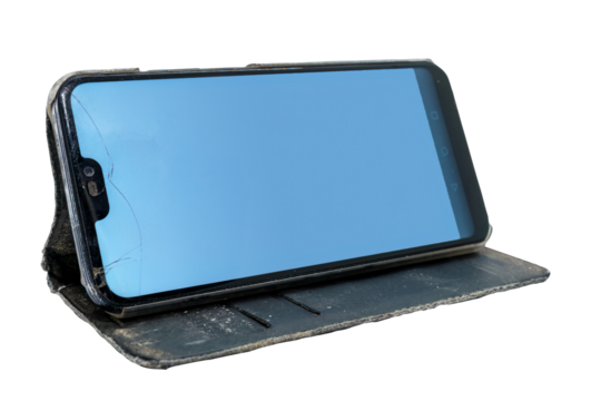 Used smart phone with cracked screen in a flip case, placed in horizontal position. Isolated 