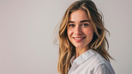 Fototapeta premium Young working woman in office clothing, smiling and looking at camera