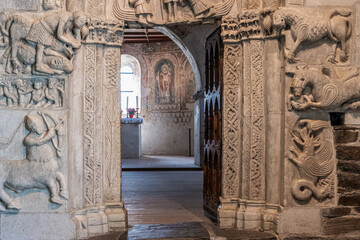 Tyrol Castle, Merano on South Tyrol, Italy, June 14, 2023: interior of the Castle: chapel portal in marble, romanesque architectural sculpture in Tyrol - obrazy, fototapety, plakaty