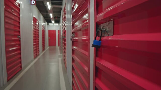 Close up selective focus shot of padlock on red door of unit in self service storage