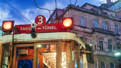 Historical  Red Tram at night with orange vehicle lights in Taksim, Istiklal avenue Istanbul, Turkey 