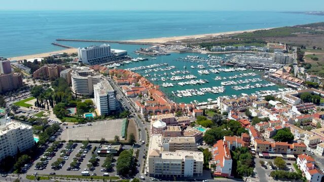 Cinematic aerial drone point of view of Vilamoura City and Harbour. Situated in South of Portugal is a famous travel destination. Drone Tracking right