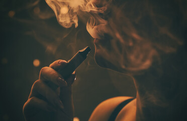 a woman with a beautiful make-up, with plump lips smokes a cigarette close-up. - obrazy, fototapety, plakaty