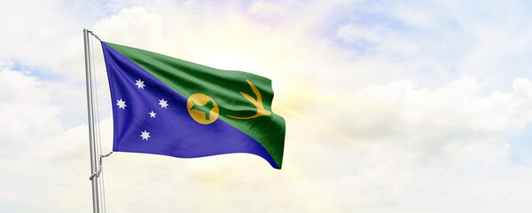 Christmas Island flag waving on sky background. 3D Rendering