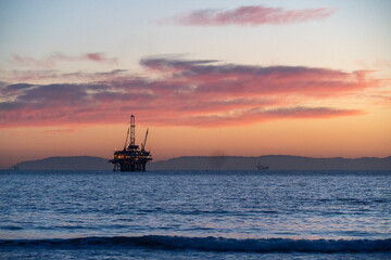 oil rig at sunset beach