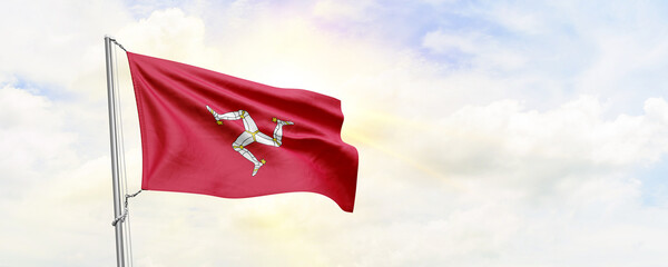 Isle of Man flag waving on sky background. 3D Rendering