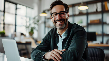 Fototapeta premium smiling businessman working with his laptop in the office