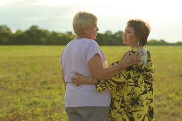 Joy illuminates the faces of two women as they embrace; a timeless moment of friendship and...