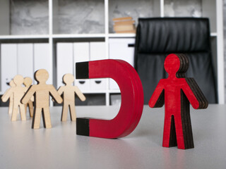 Employee retention concept. Boss with magnet.