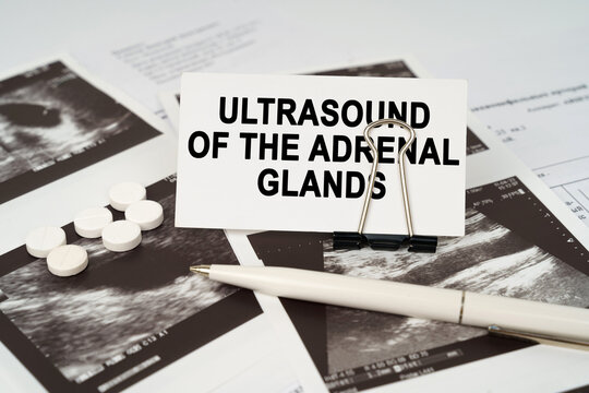 On the ultrasound pictures there is a pen and a business card with the inscription - Ultrasound of the adrenal glands