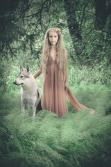 Young lady as a forest fairy in middle of summer time forest