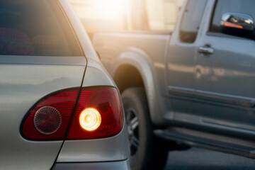 back side of car open turn signal on the road with the side of the car passed. - obrazy, fototapety, plakaty