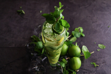 Lemon mint mojito served in disposable glass isolated on table side view of healthy drink