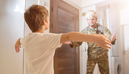 Fototapeta premium a child meets the father of a soldier who came from the war at home