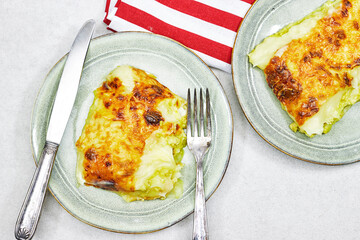 Traditional chicken shepherd pie offered as closeup in a rustic ceramic modern design plate
