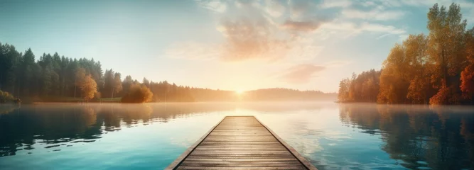 Poster wooden dock at sunrise, lake with morning sunlight © grigoryepremyan