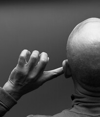 deafness suffering from hearing loss on grey black background with people stock image stock photo	