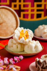 Baozi or Bakpao is a type of yeast-leavened filled bun in various Chinese cuisines. Baozi in Red Background
