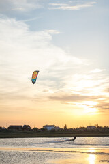 Sportsman kitesurfing during sunset