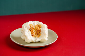 Baozi or Bakpao is a type of yeast-leavened filled bun in various Chinese cuisines. Baozi in Red Background