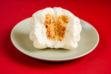 Baozi or Bakpao is a type of yeast-leavened filled bun in various Chinese cuisines. Baozi in Red Background