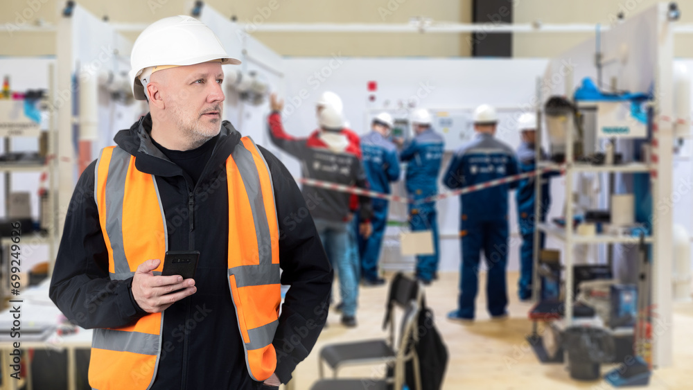 Aufkleber man is leader of construction team. manager controls factory workers. foreman is standing in industr