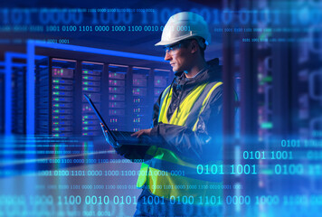 Man system administrator. Engineer with laptop stands in server room. System administrator among...
