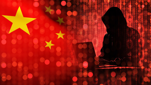 Hacker with China flag. Man computer geek in hood. Cyber developer from PRK. Hacker threat from China. Man computer scientist sits at table. White hat hacker protects China cyberspace. 3d image