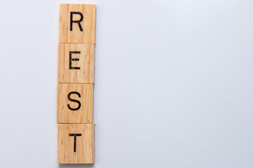 wooden letter tiles spell rest