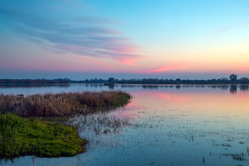 Beautiful lagoon landscape with birds in the Doñana National Park, Huelva, Anadalucia, Spain, at sunset - obrazy, fototapety, plakaty