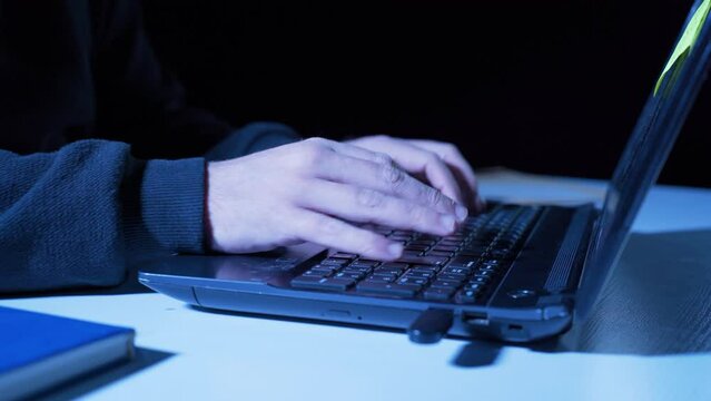 Close-up professional hacker hands.