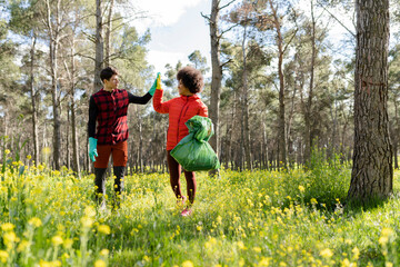Fototapeta premium multiracial volunteers collect garbage in the natural park, recycling care for the environment