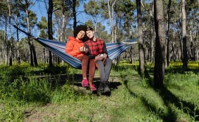 young happy couple in love in nature in a bed drinking coffee, Valentine's Day
