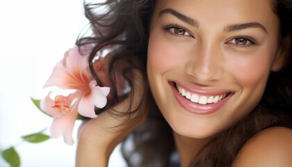 pretty smiling woman with a flower in her hand on her head, brown hair, wellness
