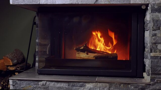 Short clip showing modern domestic fireplace with lit firewood
