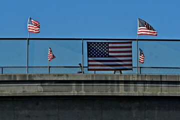 American flags on overpass showing patriotism on the 4th of July 