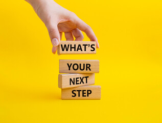 What is your next step symbol. Wooden blocks with words What is your next step. Businessman hand. Beautiful yellow background. Business concept. Copy space. - obrazy, fototapety, plakaty