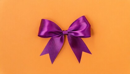 Colorful purple bow on orange background