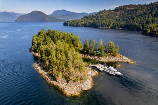 Skookumchuck Narrows with Sechelt Inlet in the Background. Sunshine Coast, British Columbia, Canada, during a pristine sunset. Aerial picture of the wild scenery. Private residential island yacht. 
