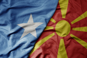 big waving national colorful flag of macedonia and national flag of somalia .