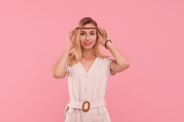 Portrait of beautiful hippie woman on pink background
