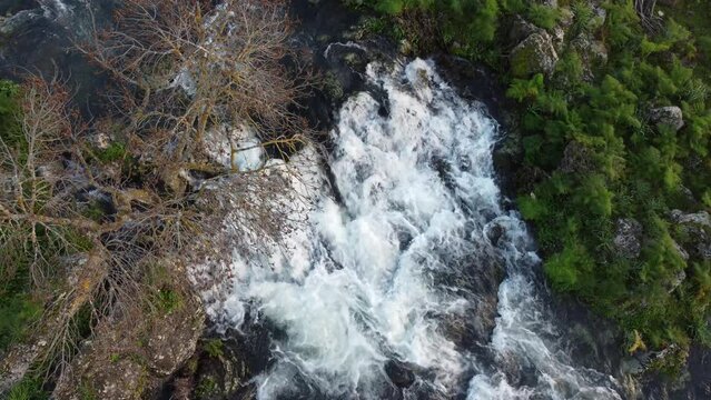 A seasonal river flows under the massive snowcovered Etna volcano. Favare Santa Venera
