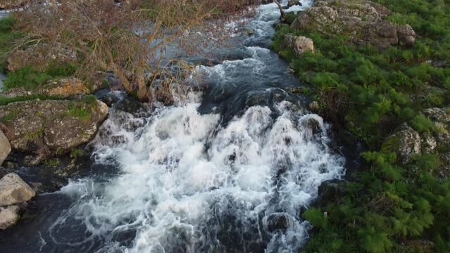 A seasonal river flows under the massive snowcovered Etna volcano. Favare Santa Venera