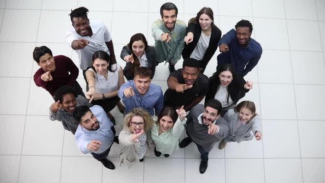 large team of young people pointing somewhere up