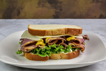 pastrami sandwich top with cheese  and mustard