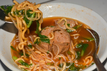 Close up photo of a bowl of meatballs with delicious sauce