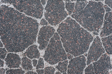 Background, texture, top view of wet asphalt with cracks on the road. Photography, abstraction.