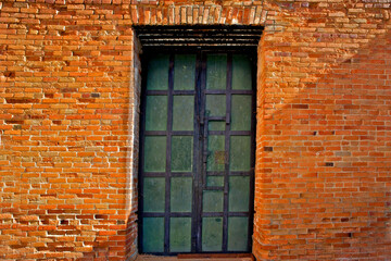 Fototapeta na wymiar Merchant door and old brick wall, Shasta, California 